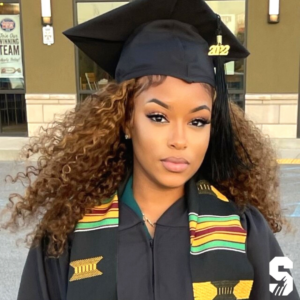 young black woman wearing graduation cap and gown